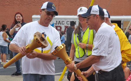 Larry Lemen and Owen Menchhofer light torch