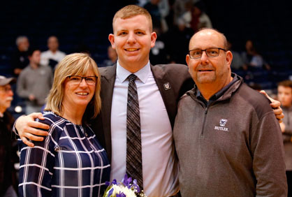 Pat Baker stands between his parents Stephanie and Michael